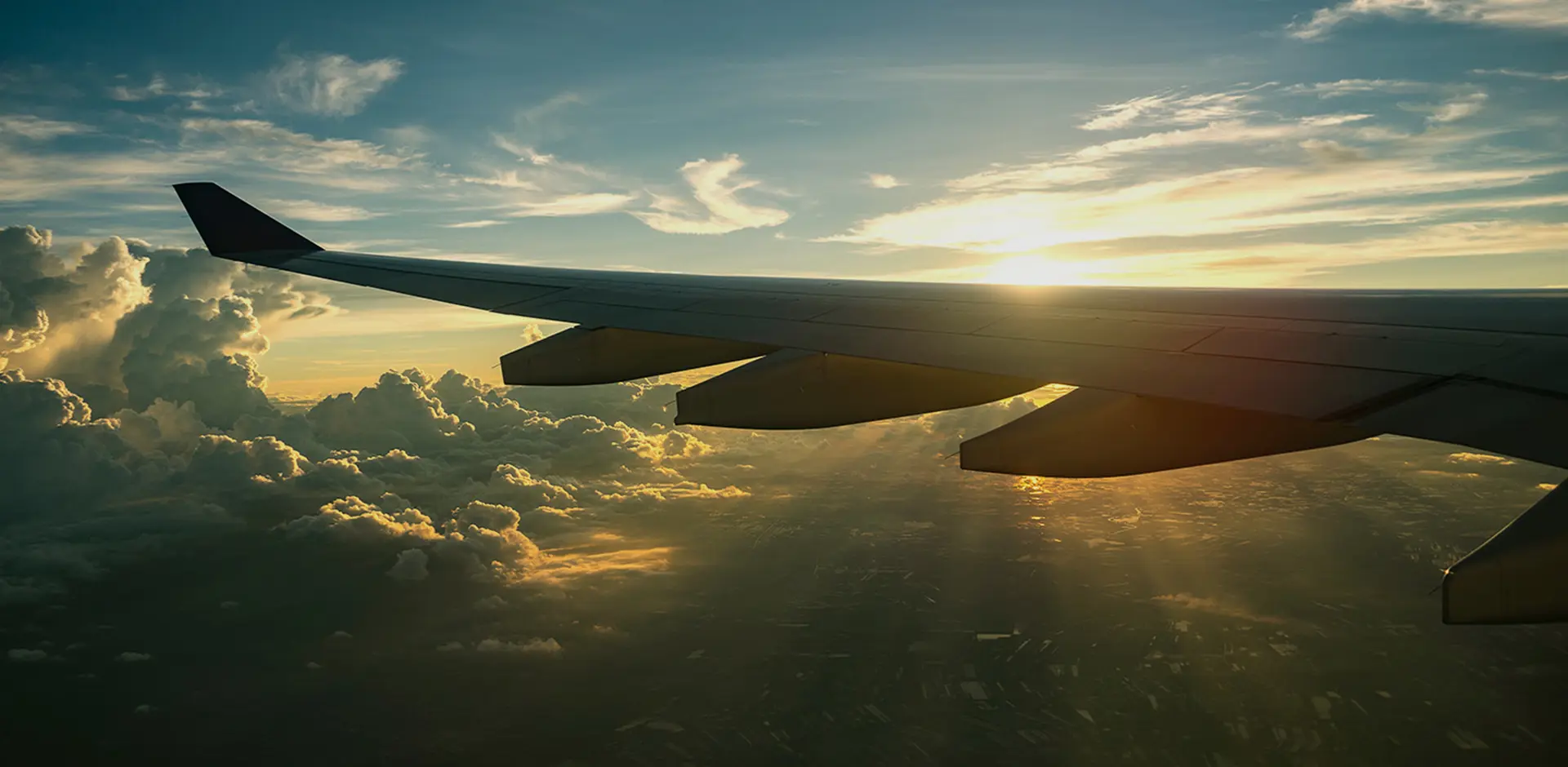 airplane-wing-sunset-clouds-view
