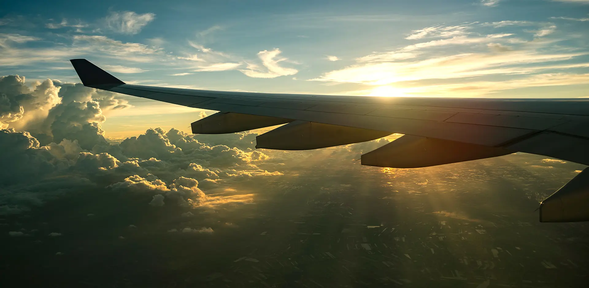 airplane-wing-sunset-clouds-view