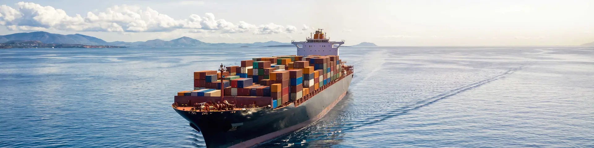 cargo-ship-sailing-near-mountains